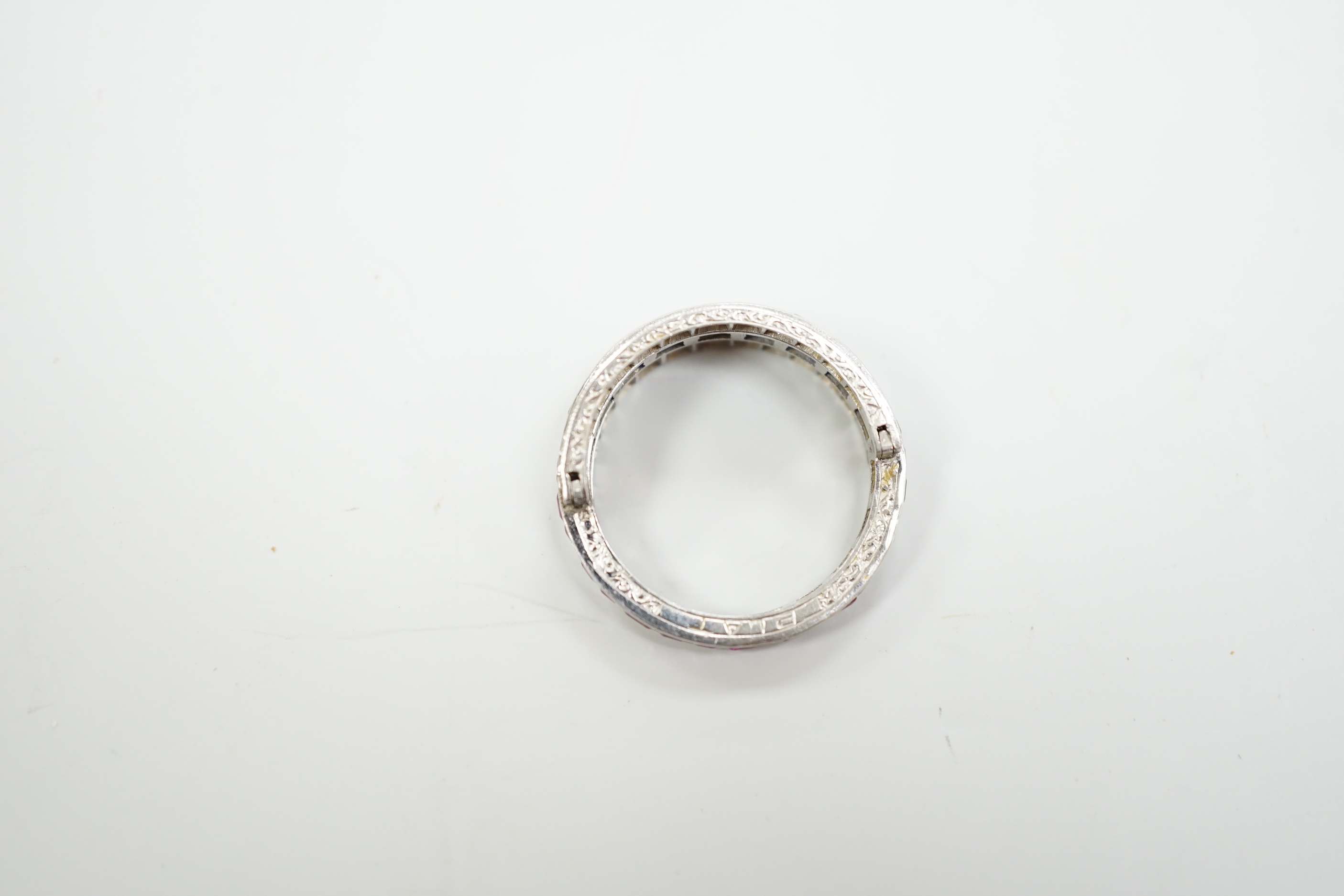 An early to mid 20th century platinum?, ruby, sapphire and diamond set swivelling triple band half eternity ring, size Q, gross weight 4.6 grams.